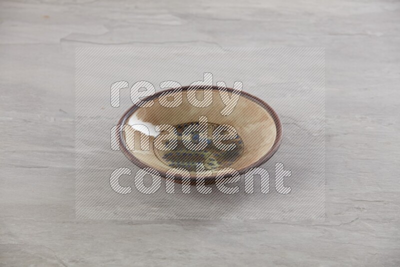 multi color ceramic round plate on grey textured countertop