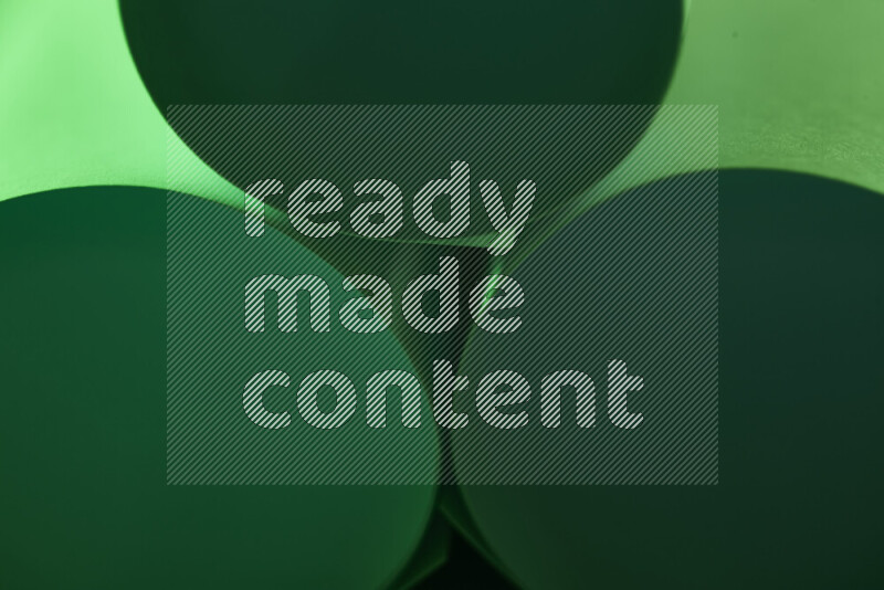 The image shows an abstract paper art with circular shapes in varying shades of green