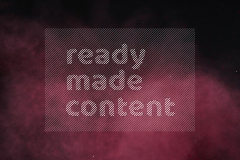 Red powder explosion on black background