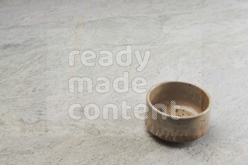 A multicolored pottery bowl on grey marble background