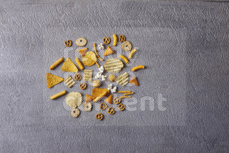 Assorted snacks in pottery bowls on grey background