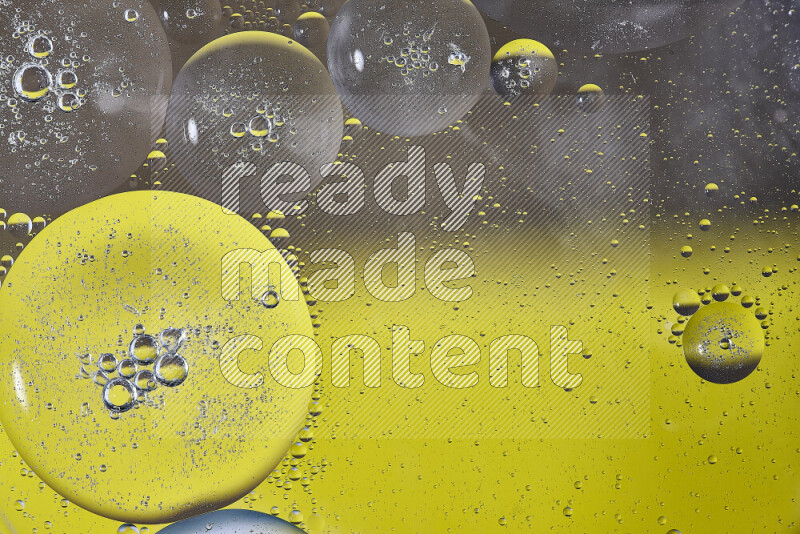 Close-ups of abstract oil bubbles on water surface in shades of yellow and brown