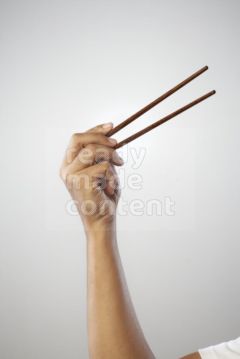 Male Hand Holding Chop Stick on white background