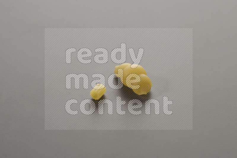 Small rings pasta with other types of pasta on grey background