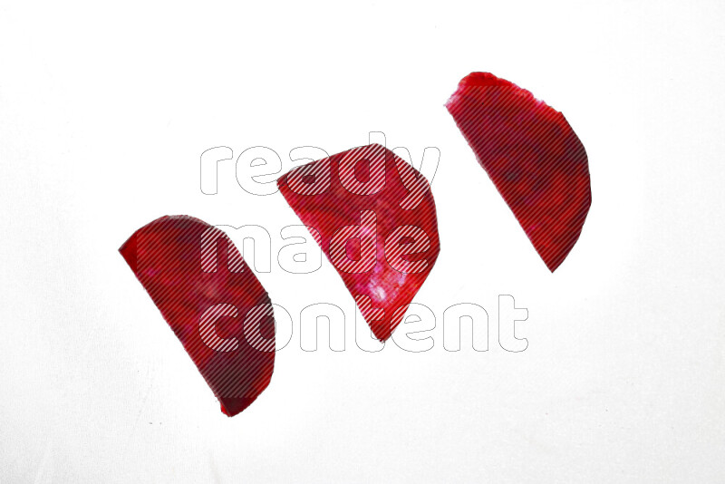 Beet slices on illuminated white background