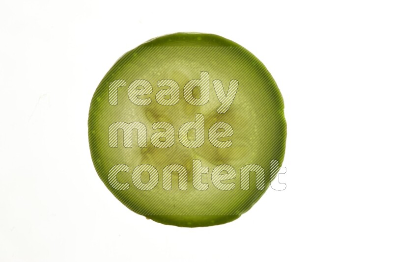 Zucchini slices on illuminated white background