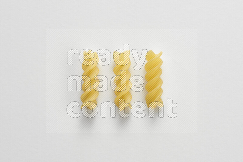 Fusilli pasta on white background