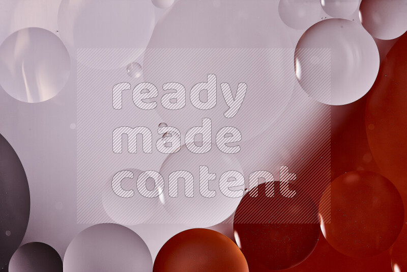 Close-ups of abstract oil bubbles on water surface in shades of white and orange