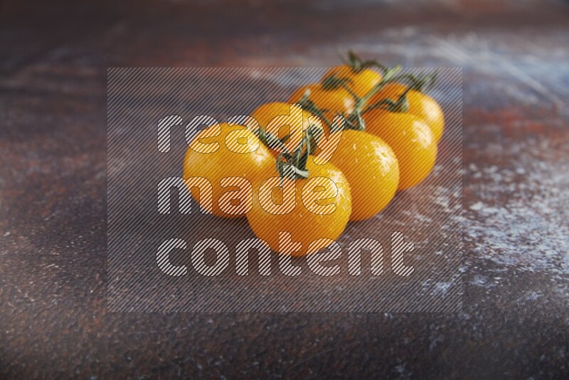Yellow cherry tomato vein on reddish rustic metal background 45 degree