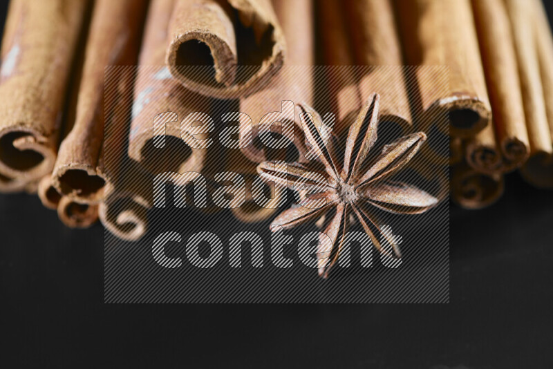Cinnamon sticks and star anise on black background
