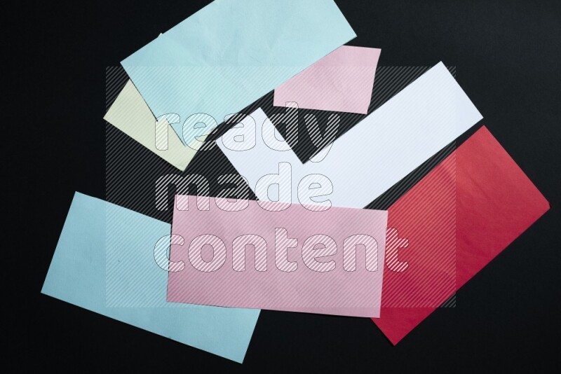 Multicolored paper sheet on black background