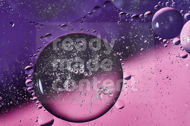 Close-ups of abstract oil bubbles on water surface in shades of purple and pink