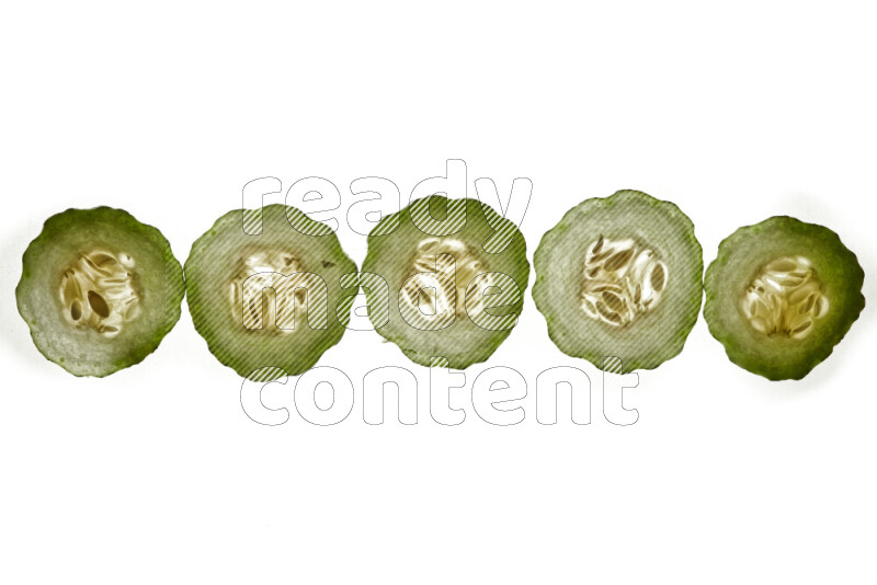 Cucumber slices on illuminated white background