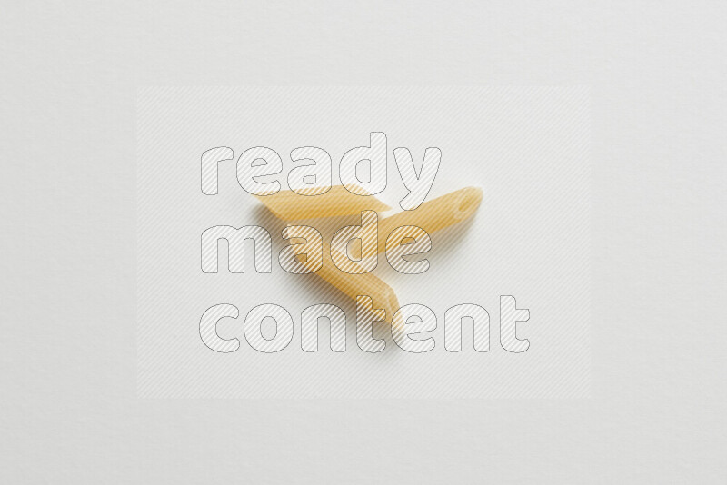 Mini penne pasta on white background