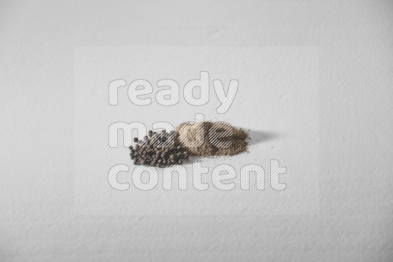 Black pepper powder and beads on a white background
