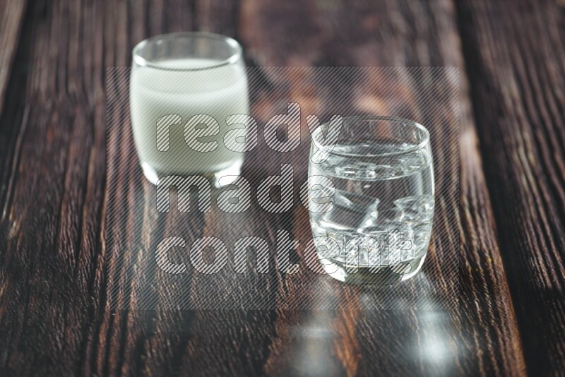 Cold drinks in a glass cup such as water, tamarind, qamar eldin, sobia, milk and hibiscus on wooden background