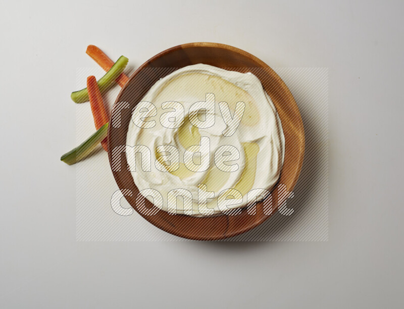 Lebnah garnished with olive oil in a wooden plate on a white background