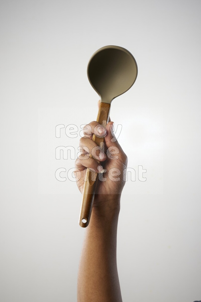 Male Hand Holding ladle on white background