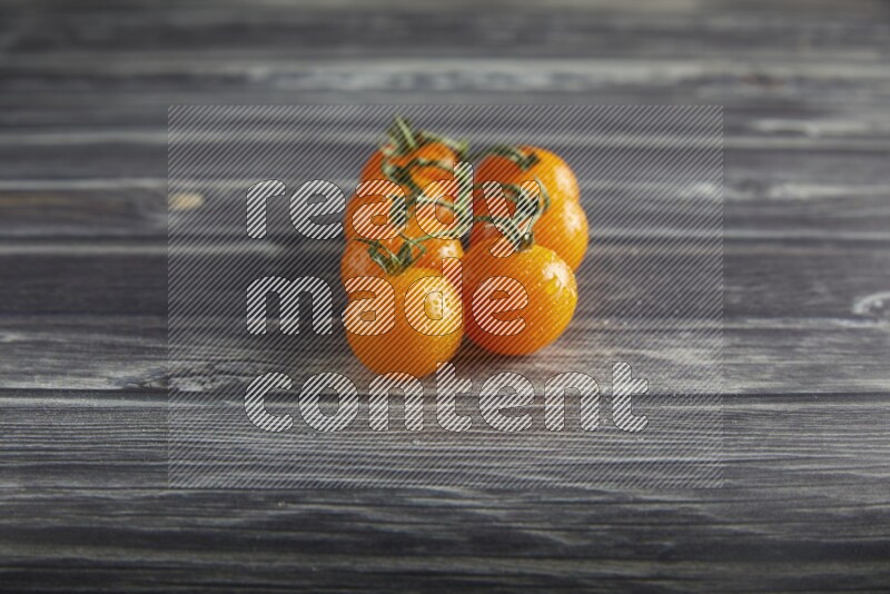 orange cherry tomato vein on a textured grey wooden background 45 degree