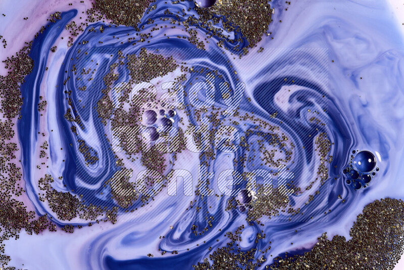 A close-up of sparkling gold glitter scattered on swirling blue and red background