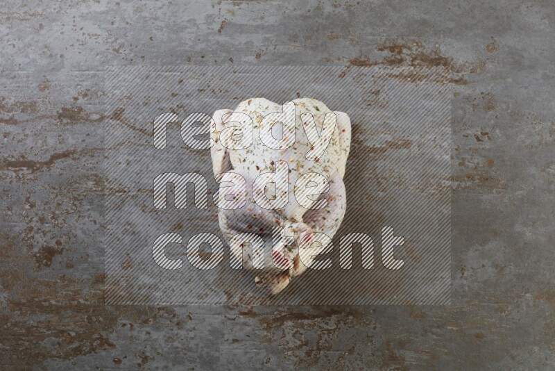 whole raw chicken  direct on a rustic grey background
