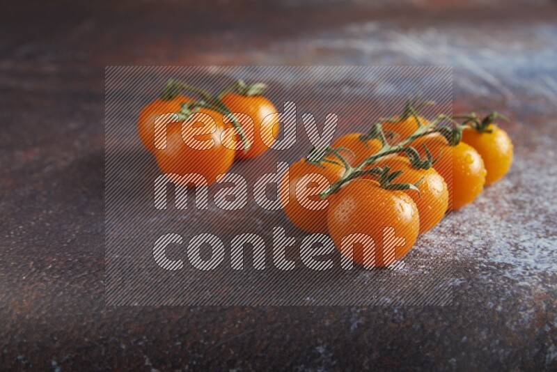 Orange cherry tomato vein on reddish rustic metal background 45 degree