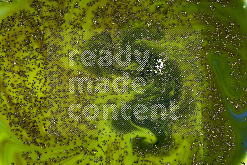 A close-up of sparkling gold glitter scattered on swirling green background