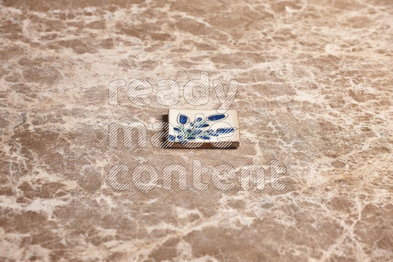 A decorative coaster on beige marble background