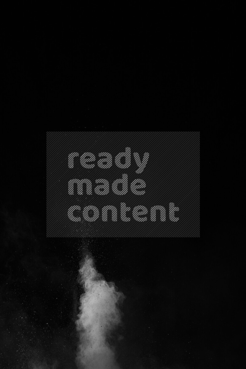 A side view of white powder explosion on black background