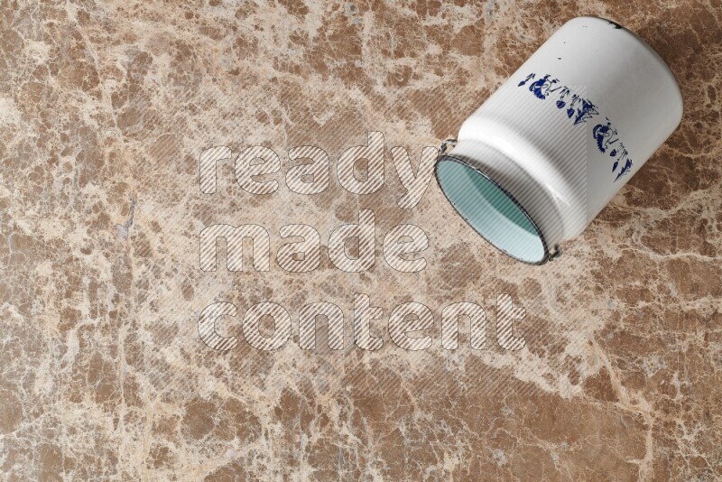 A vintage milk can on beige marble background