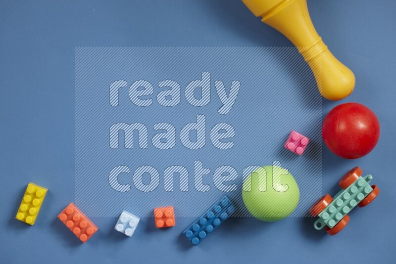 Plastic building blocks, balls and bowling pins on different colored backgrounds (kids toys)
