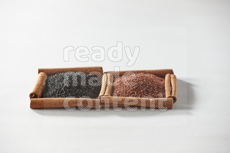 2 squares of cinnamon sticks full of black seeds and garden cress on white flooring