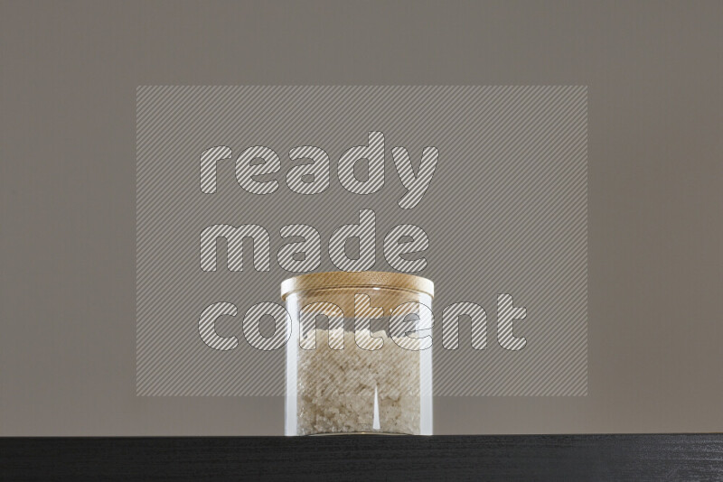 Salt in a glass jar on black background