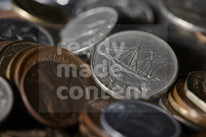 A close-ups of random old coins on black background