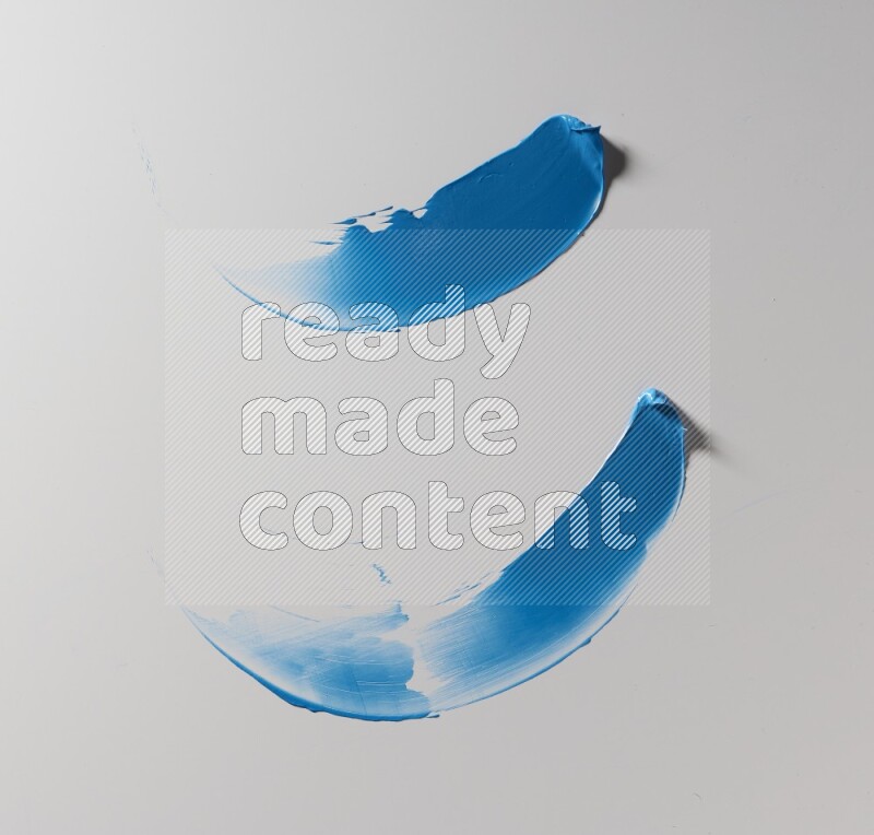 Blue curved painting knife strokes on white background