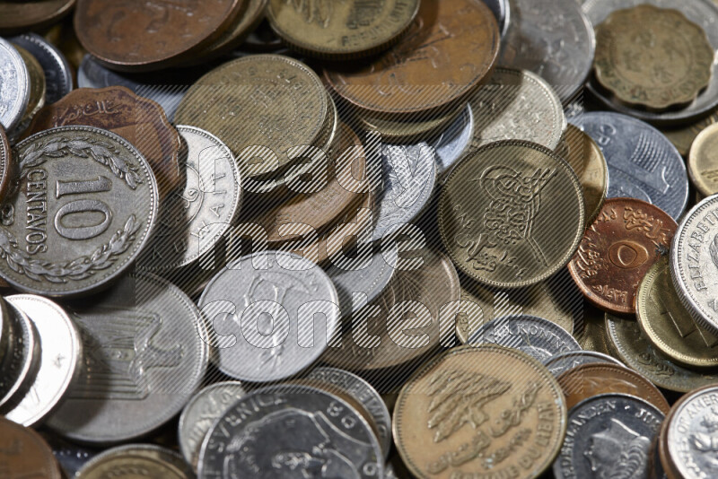 A close-ups of random old coins on black background