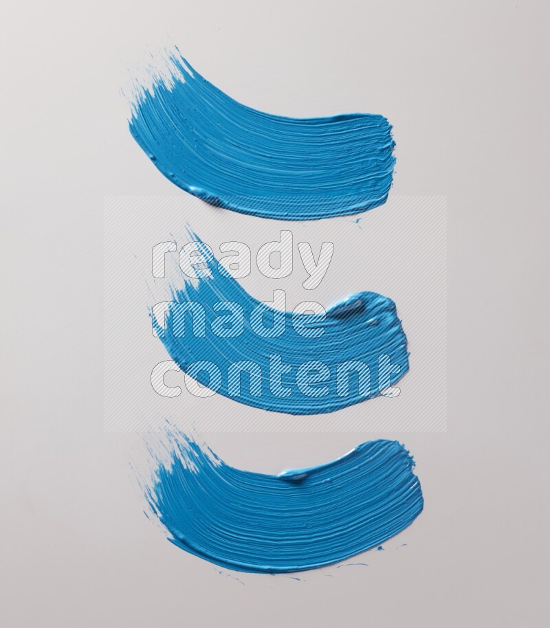 Multi blue curved brush strokes shaped into different shapes on a white background