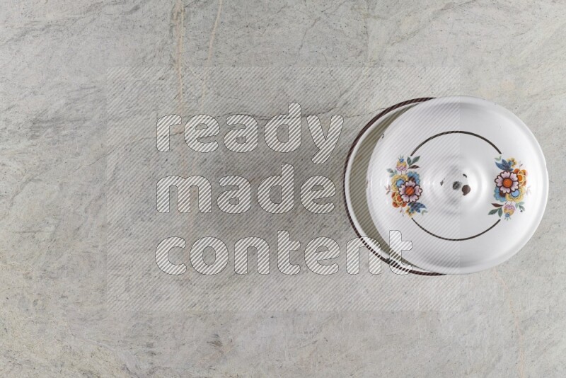 A vintage metal pot on grey marble background