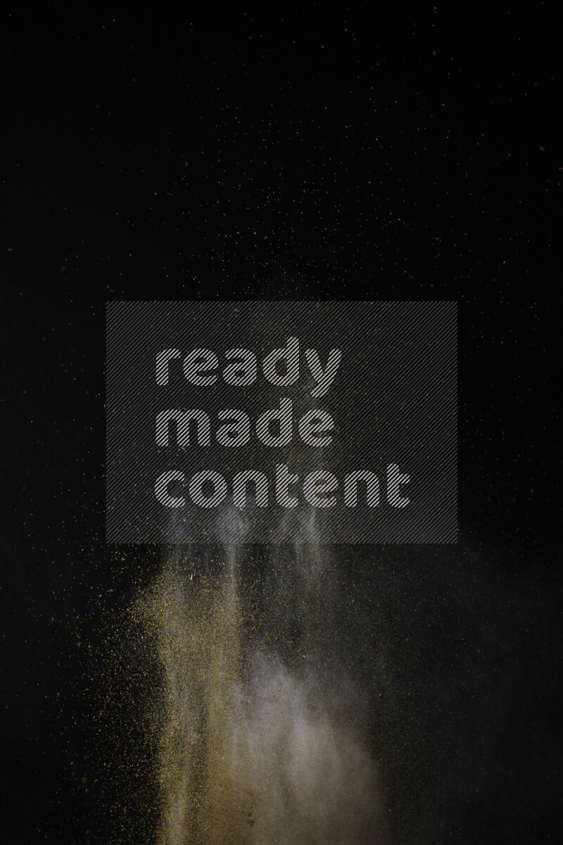 A side view of brown powder explosion on black background