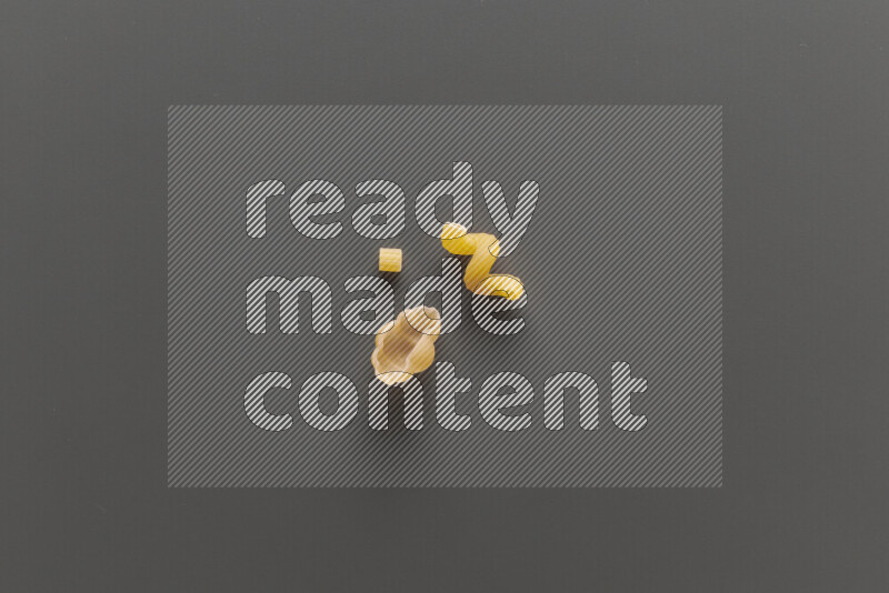 Different pasta types on grey background