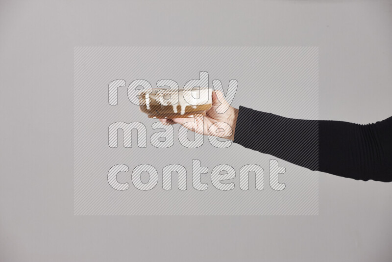 A woman in black abaya holding different pottery essentials in different positions