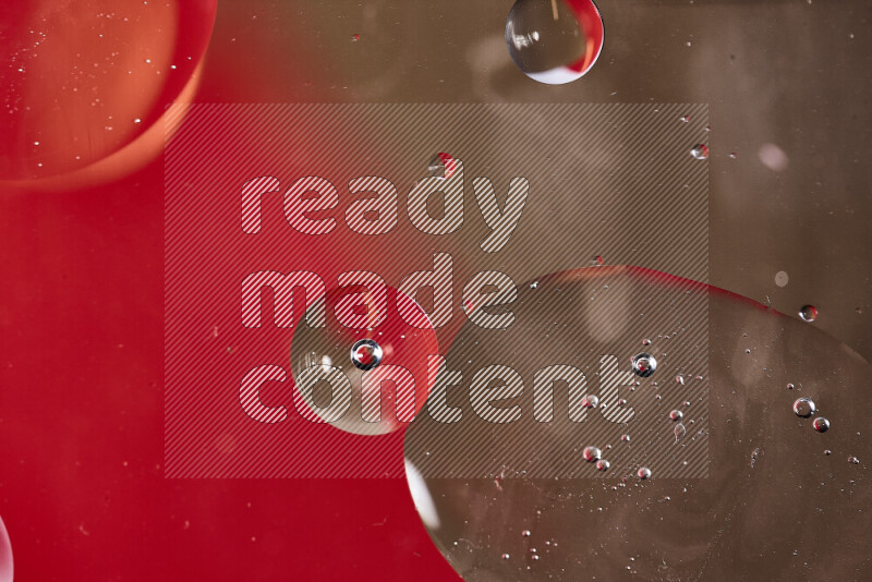 لقطات مقربة لفقاعات من الزيت على سطح الماء باللون الأحمر والبني