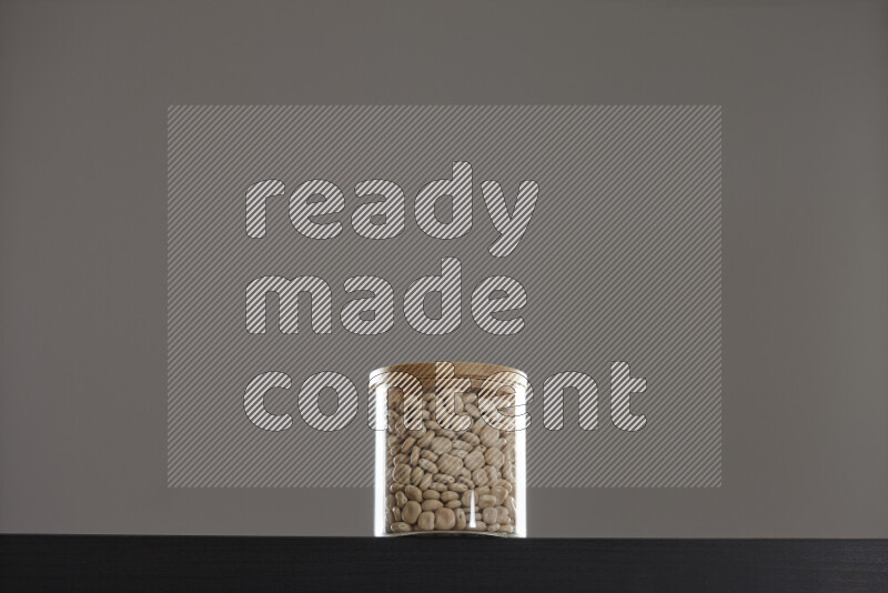 Lupin Beans in a glass jar on black background