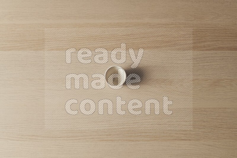 A pottery cup on light wooden background