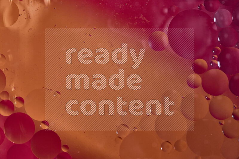 Close-ups of abstract oil bubbles on water surface in shades of red and orange