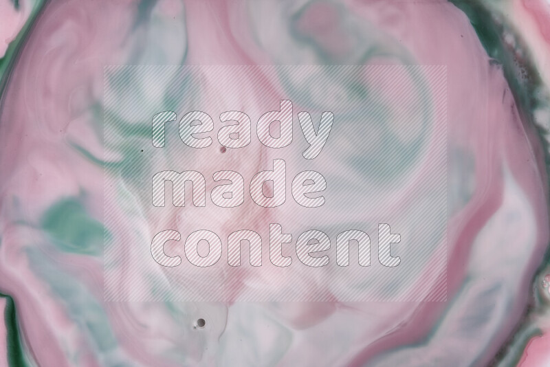 A close-up of abstract swirling patterns in red and green