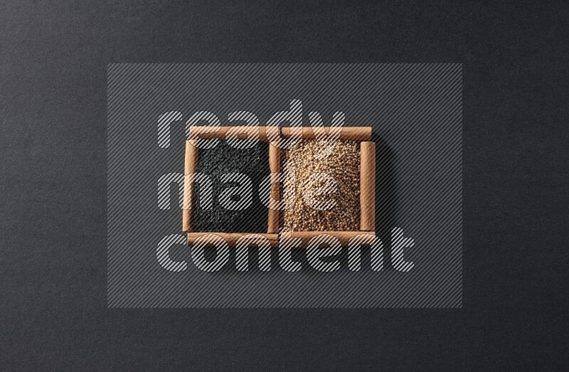 مربعان من أعواد القرفة ممتلئان بحبوب الخردل وحبة البركة السوداء علي خلفية سوداء