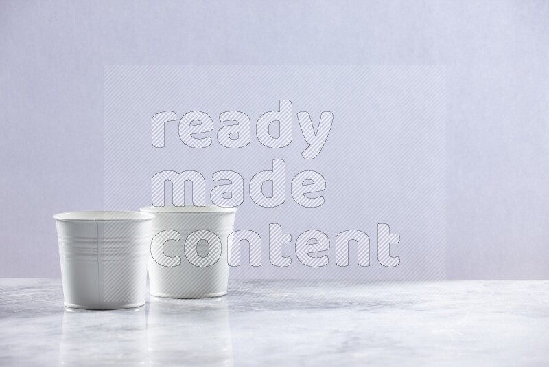 An empty white plant pot on grey marble background