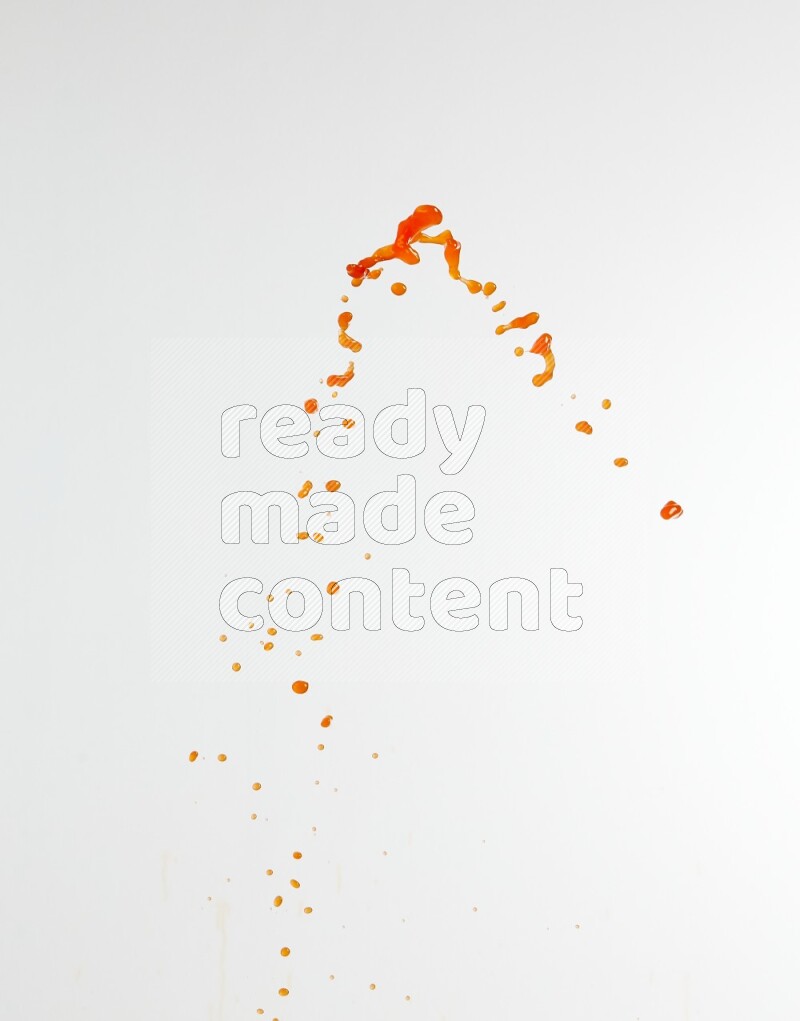 Orange liquid splash and drops on white background