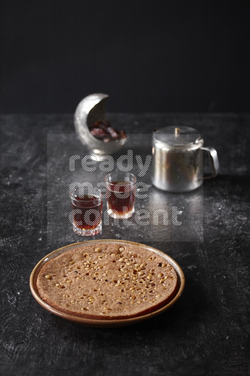 Basbousa with tea in a dark setup